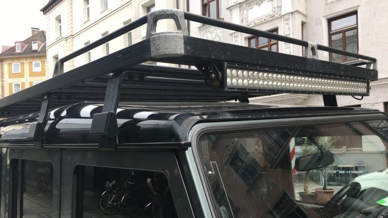 Roof rack platform with a light bar on top of an SUV