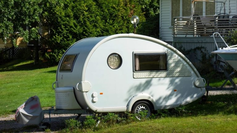 Small teardrop camper trailer parked on a lawn