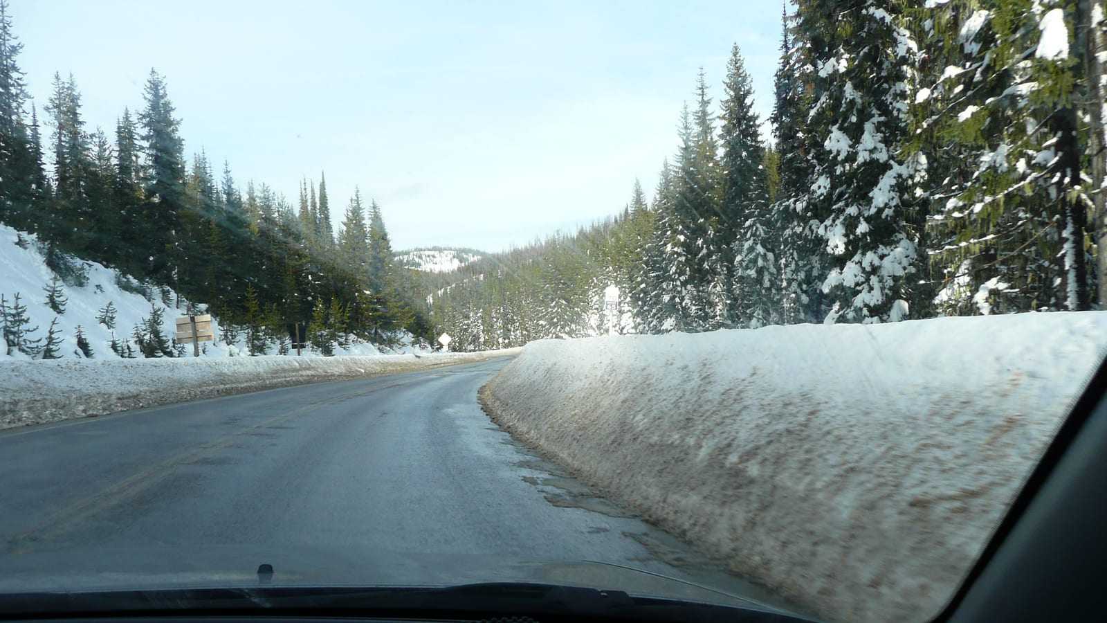 When to Put On Winter Tires and What the Snowflake Means Simolary Snow lined mountain highway through evergreen forest seen from inside a car
